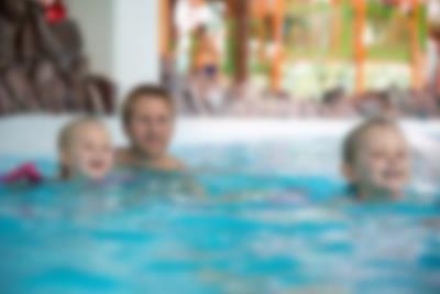 A father and daughter splash around in the stream pool in the Aquadome Lalandia Rødby